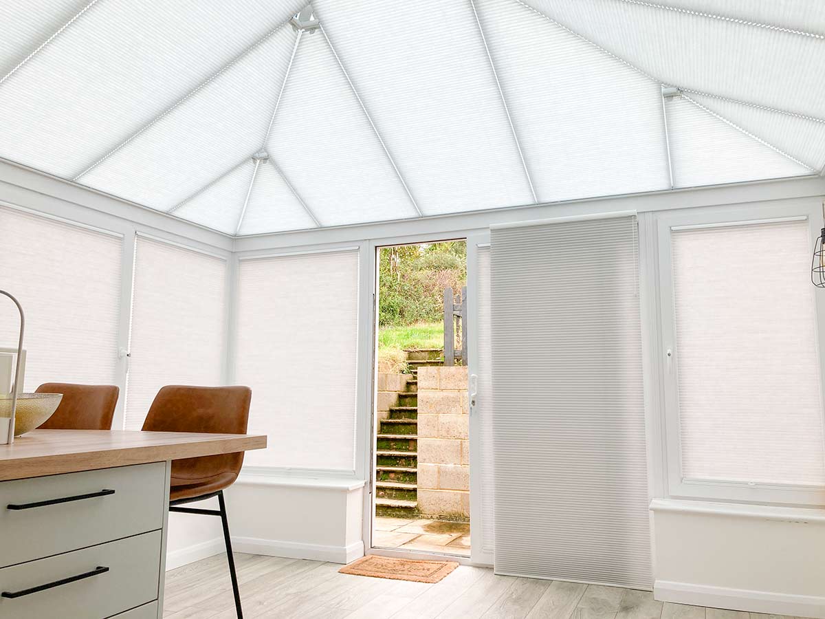 Duette® Free-hanging blinds on a sliding door in a conservatory