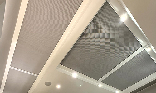 3 Lantern Roof Blinds next to each other on large spotlit ceiling