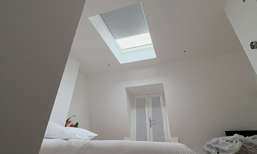 White modern bedroom with electric roof lantern blinds